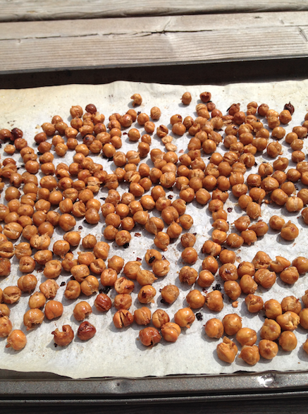 Baking sheet with Spicy Oven Roasted Chickpeas laying out on it; a great protein packed snack, or crunchy salad topper. Easy recipe, bursting with spice, and healthy. Vegan, gluten free, dairy free, and sugar free!  || Nikki's Plate
