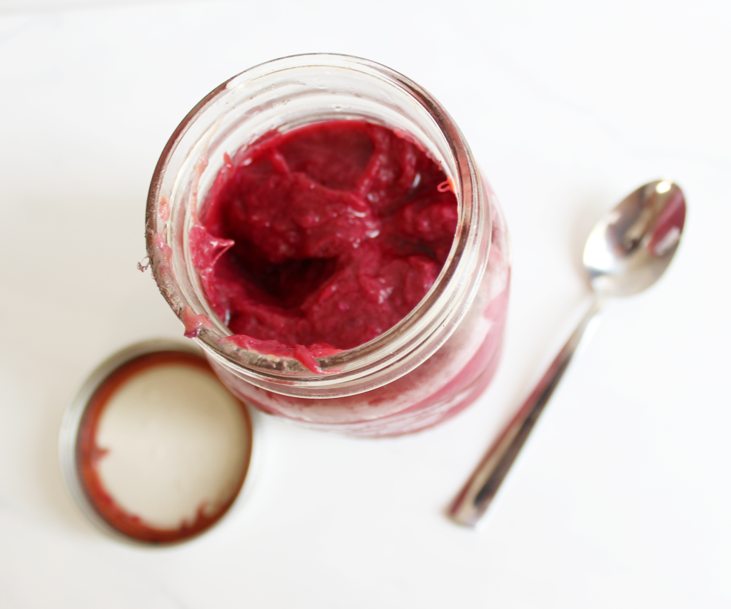 Healthy Strawberry Rhubarb Jam - mason jar with lid off of red rhubarb and strawberry jam. Chia seeds added for thickness. || Nikki's Plate