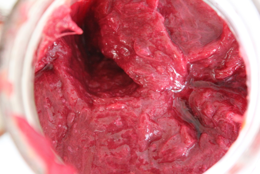 Healthy Strawberry Rhubarb Jam - bird eye view of mason jar of wet red rhubarb and strawberry jam. Chia seeds added for thickness. || Nikki's Plate