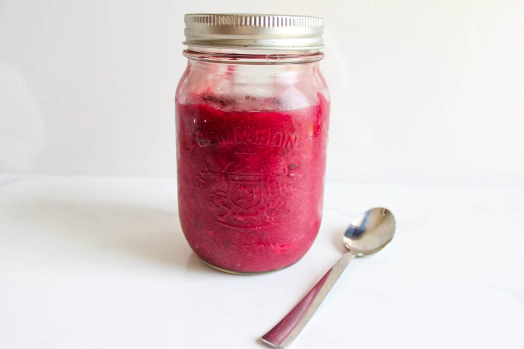 Healthy Strawberry Rhubarb Jam - mason jar of red rhubarb and strawberry jam. Chia seeds added for thickness. || Nikki's Plate