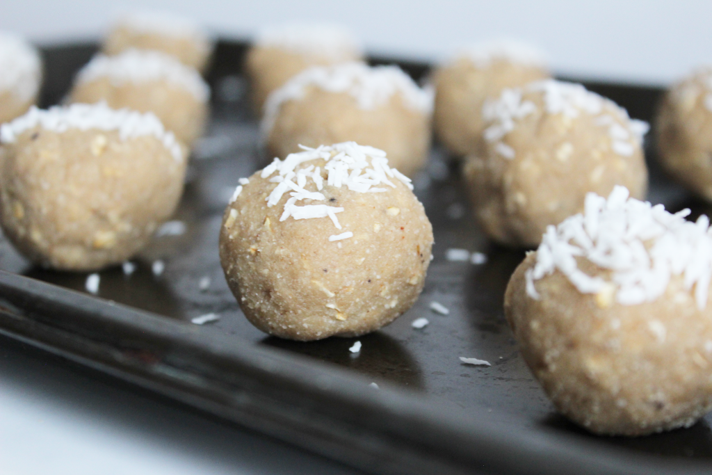 Beige coloured Apple Pie Protein balls with shredded coconut on top - gluten free and vegan