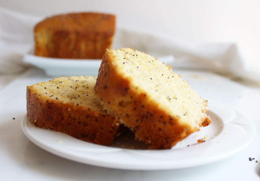 Side view of two pieces of Lemon Poppy Loaf on a small plate- Vegan and Gluten Free