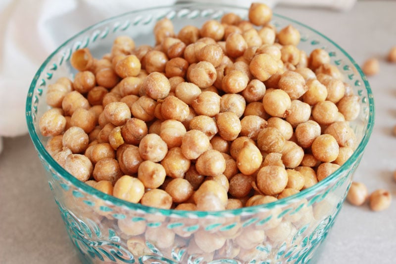 Bowl of Roasted Salt and Vinegar Chickpeas. Brown, crunchy, vinegary snack - gluten free and vegan