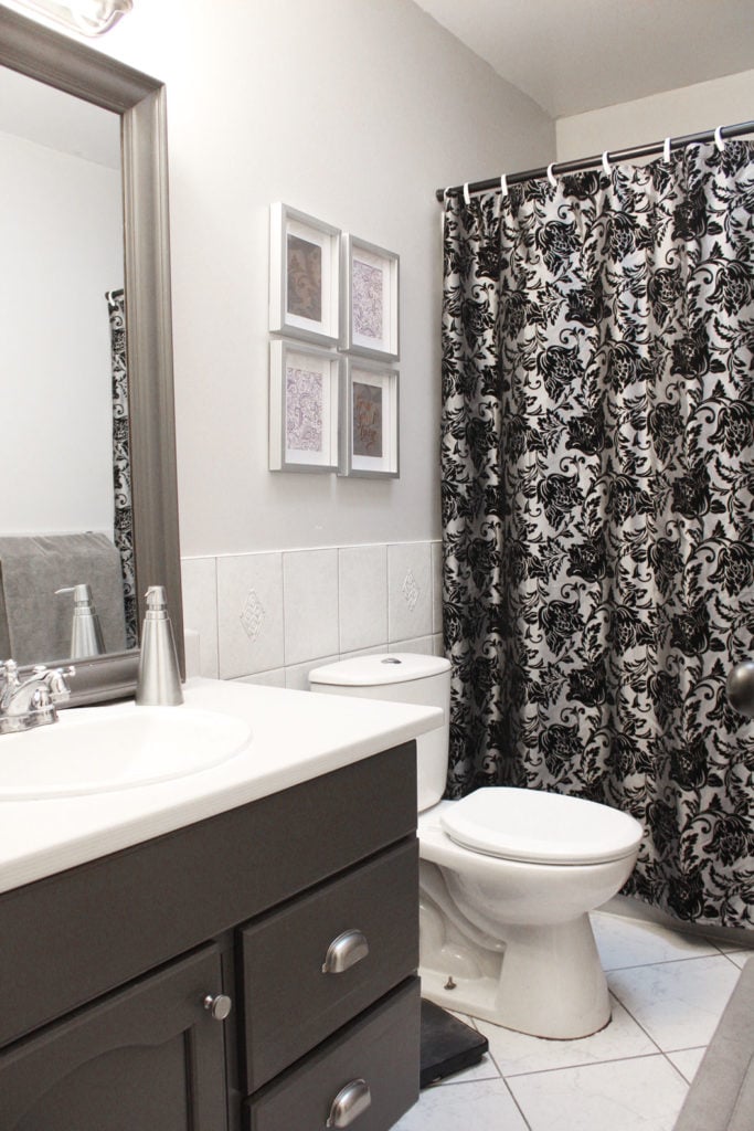 Our bathroom makeover included bright white paint, updating the bathroom vanity, and adding a new mirror