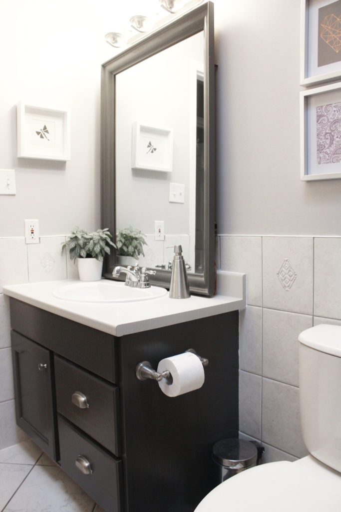 We replaced the mirror and painted the vanity, and now there's a lot more open space in the room.