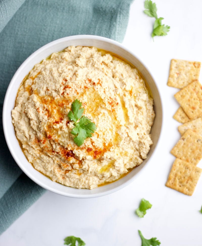 Delicious bowl of Spicy Chipotle Hummus with a few crackers || www.nikkisplate.com