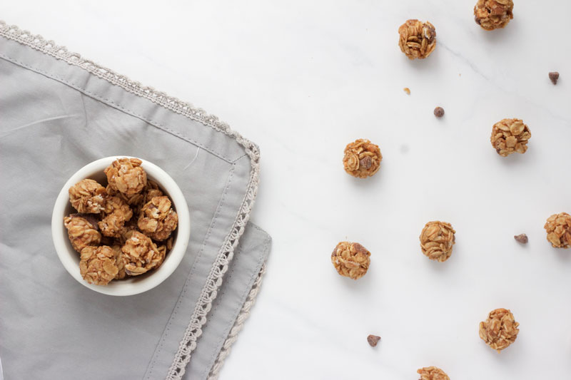 Mini Chocolate Chip and Oat Energy Balls in a bowl and on the marble top counter. Grey napkin- www.nikkisplate.com