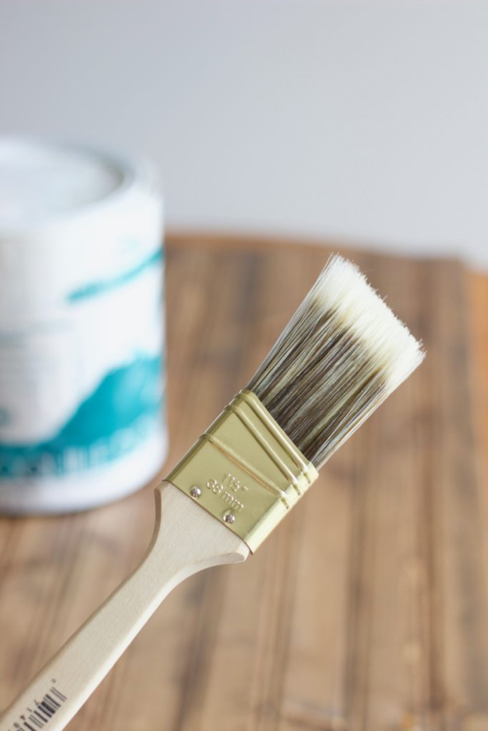 I used this small paintbrush to apply the first light layer of white paint to my stained wood