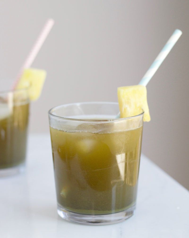Sweet pineapple juice mixed with matcha powder is a refreshing, healthy drink that's perfect for summer.
