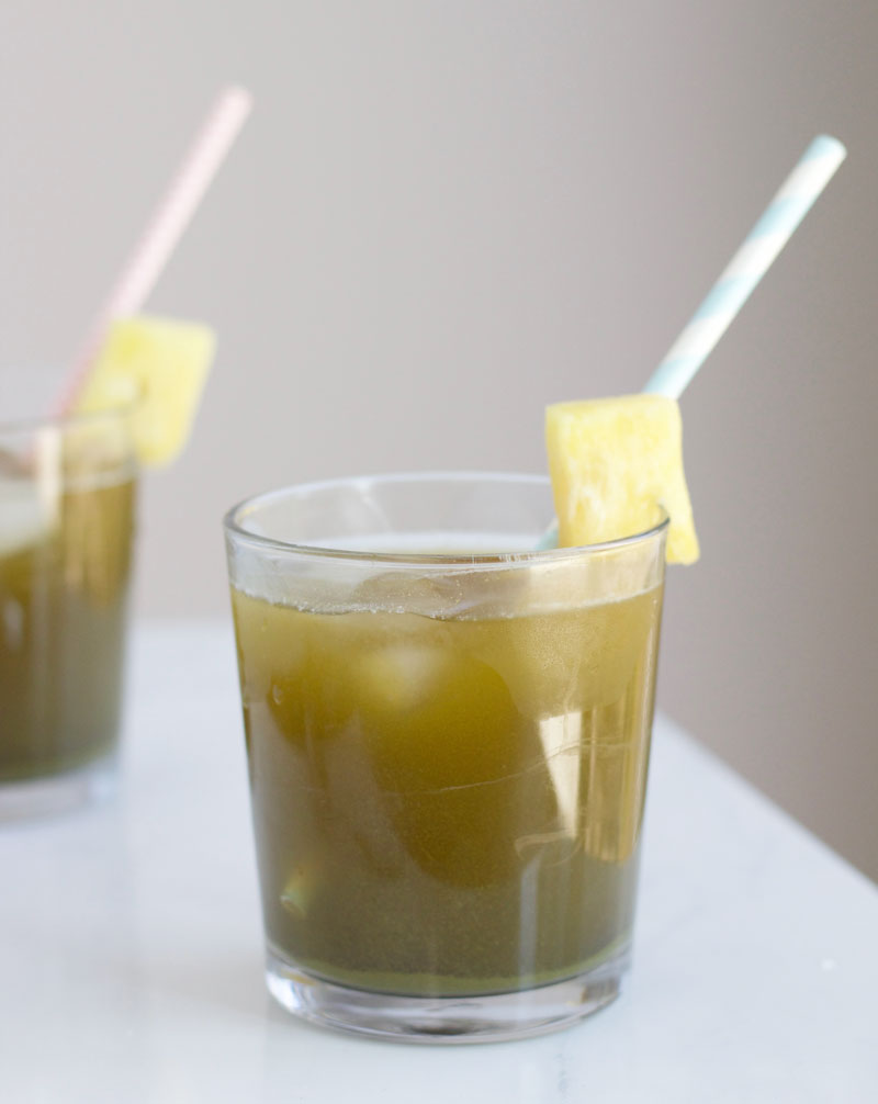 Sweet pineapple juice mixed with matcha powder is a refreshing, healthy drink that's perfect for summer.