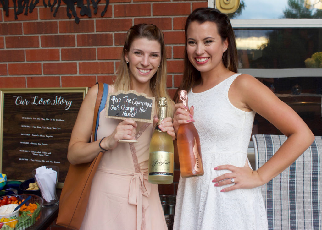 Nikki and her maid of honor celebrate at Nikki's engagement party with some champaign