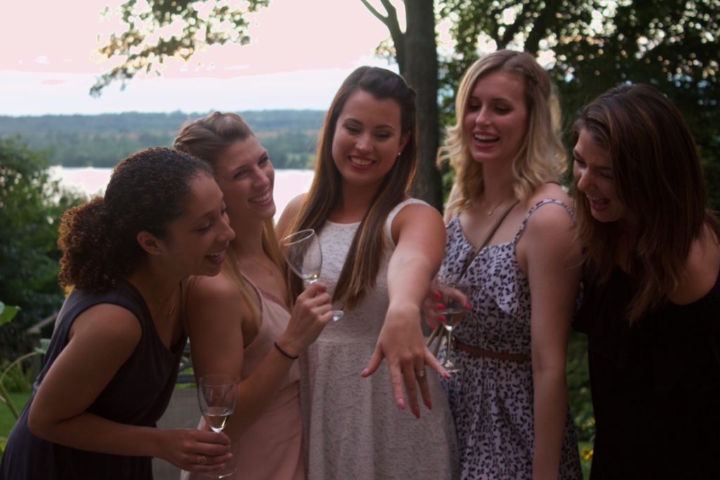 Nikki and her close girl friends gather to admire Nikki's new engagement ring