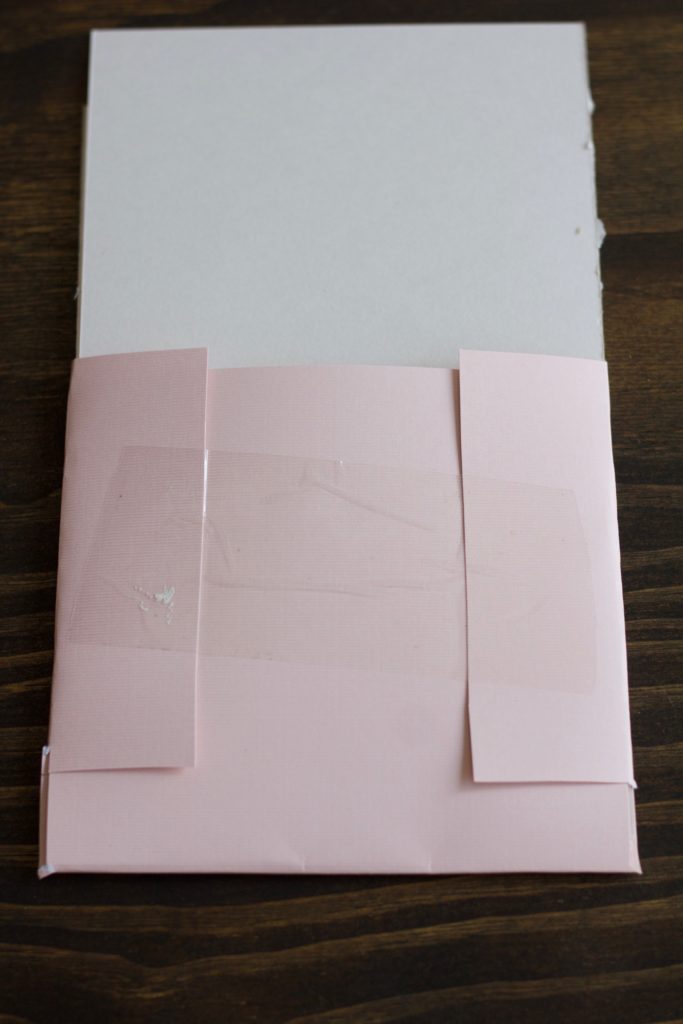 Use tape to secure the folder for your bridesmaid proposal info cards