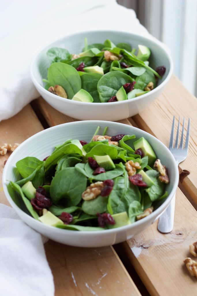 This fresh cranberry walnut salad is made with crisp spinach, apples, and topped with a honey ginger dressing