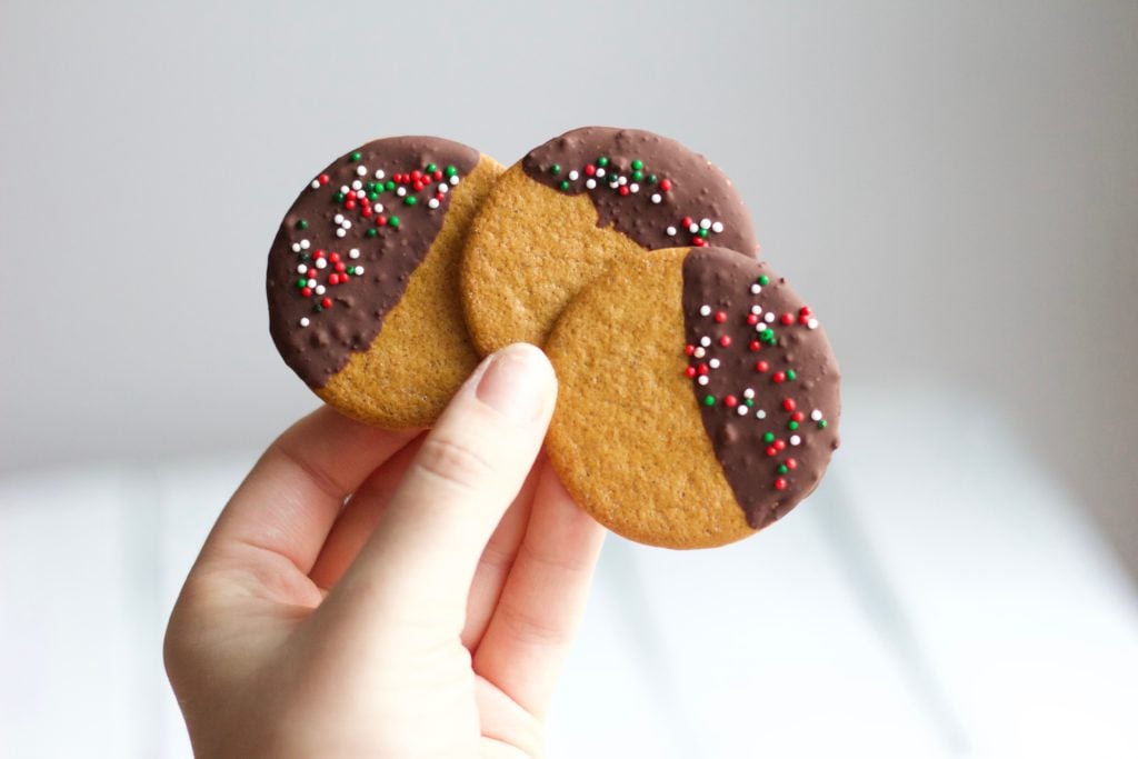 Gluten Free Chocolate Dipped Gingersnaps || Three round Gingersnaps coated in dark chocolate and green and red sprinkles || Nikki's Plate by Nikki Bahan