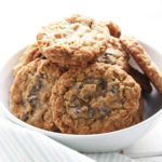 Softest Gluten Free Oatmeal Chocolate Chip Cookies: the most irresistible combination for perfectly chewy chocolate chip cookies made with dairy free chocolate chips, soft delicious oats and creamy almond butter! Vegan, Gluten-Free, Dairy-Free. || Nikki's Plate www.nikkisplate.com