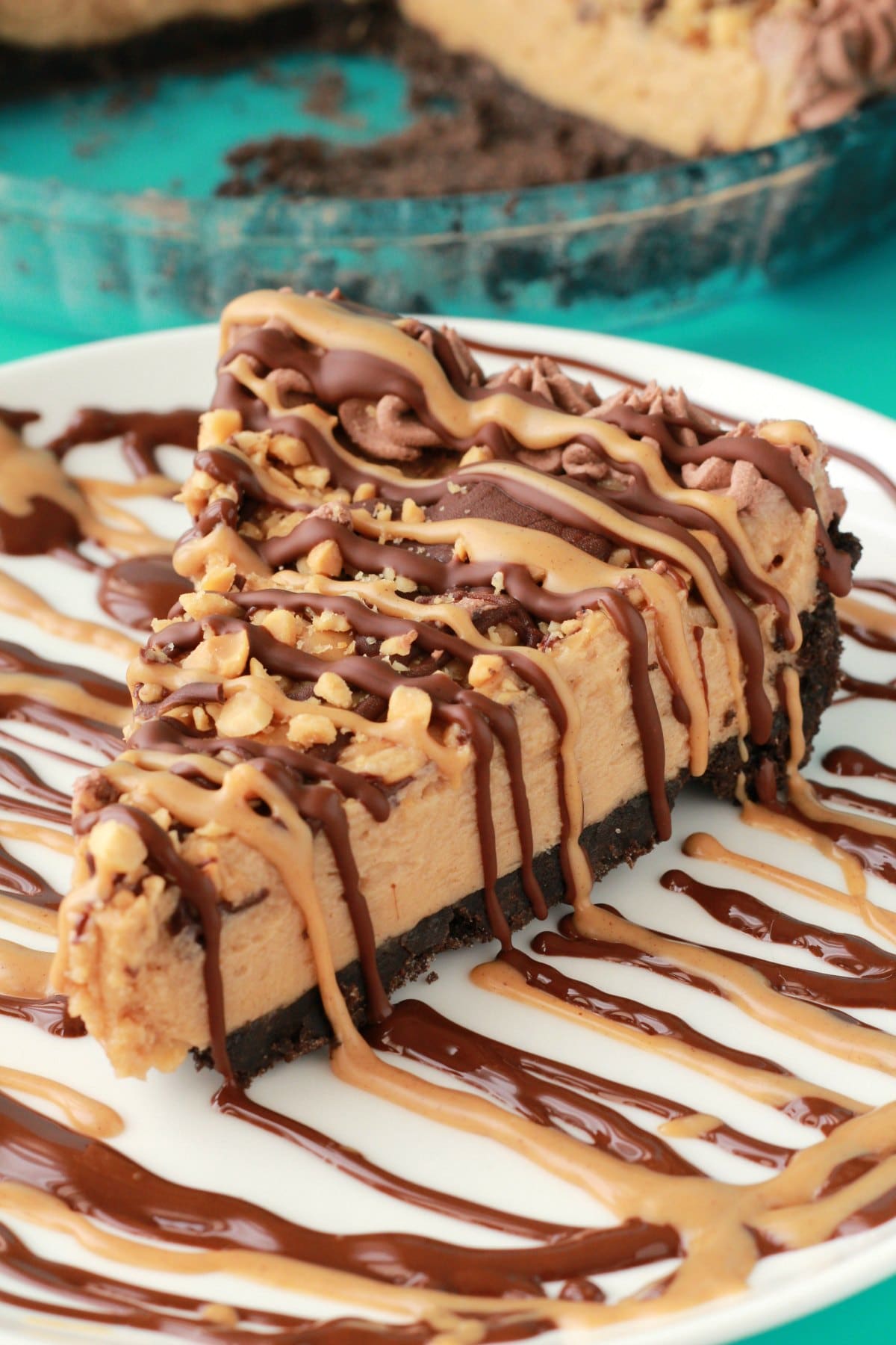 Vegan peanut butter pie is sweet, creamy, and deliciously rich. Topped with chocolate and peanut butter drizzle and peanut crumble