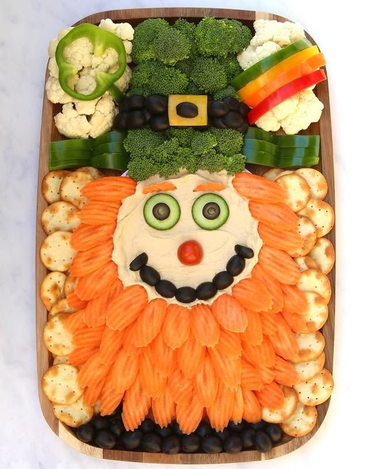 Healthy St Patrick's Day leprechaun veggie platter made with broccoli, carrots, crackers, and dip