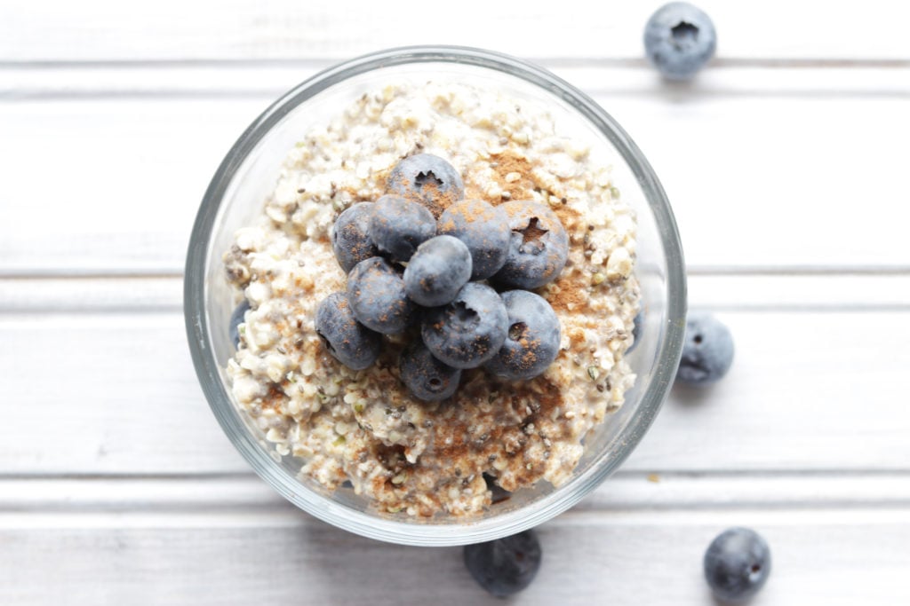 Creamy vanilla blueberry overnight oats topped with a sprinkle of cinnamon