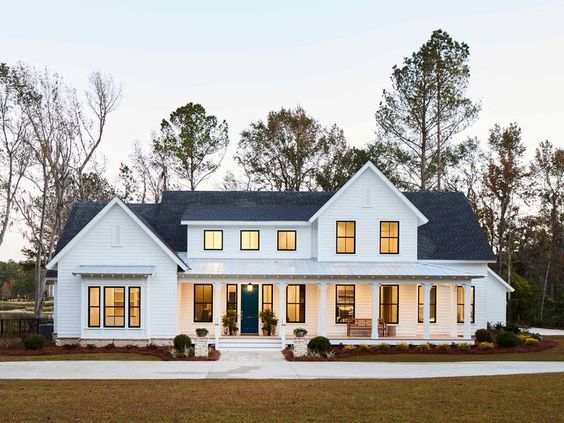 The black window trim on this all-white farmhouse style house exterior makes the windows pop!