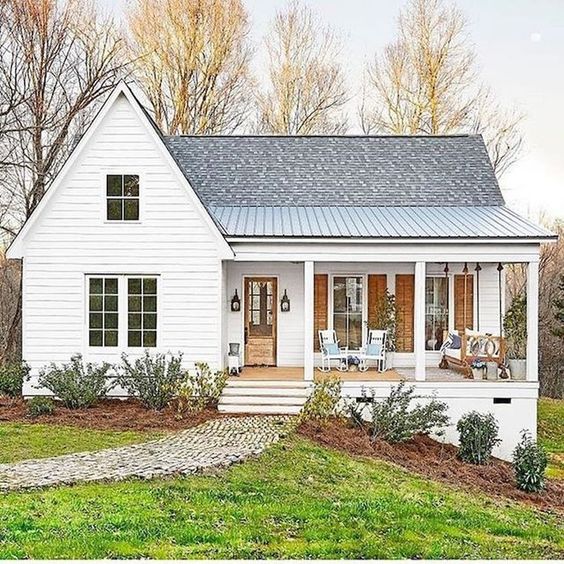 This country style front porch adds the perfect farmhouse touch to the exterior of this home