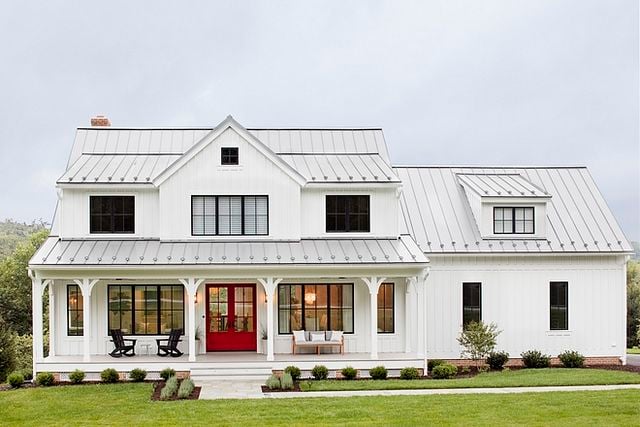 I love the look of the tin roof on this farmhouse style home, its the perfect color contrast with the all-white exterior!