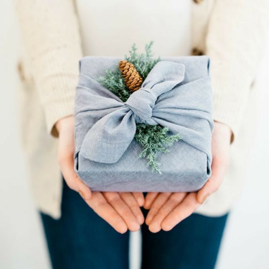 This powder blue fabric is the perfect zero-waste gift wrap, and the fur branch is a perfect seasonal touch