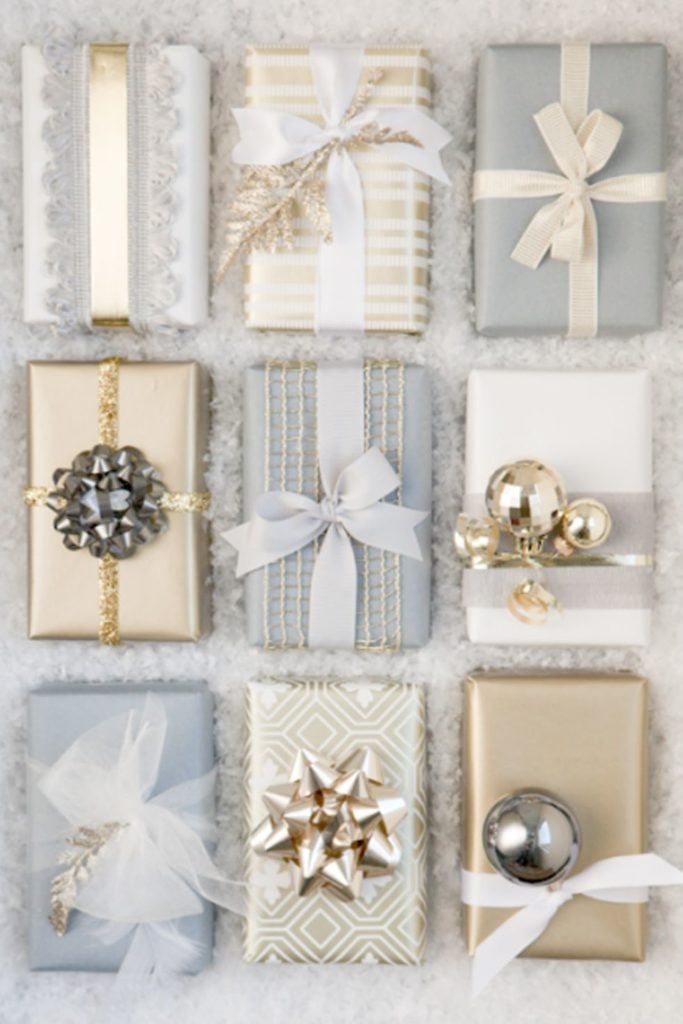 This gift wrapping is elegant and classy, but the golf and silver ribbons, bows, and bells as such a fancy touch