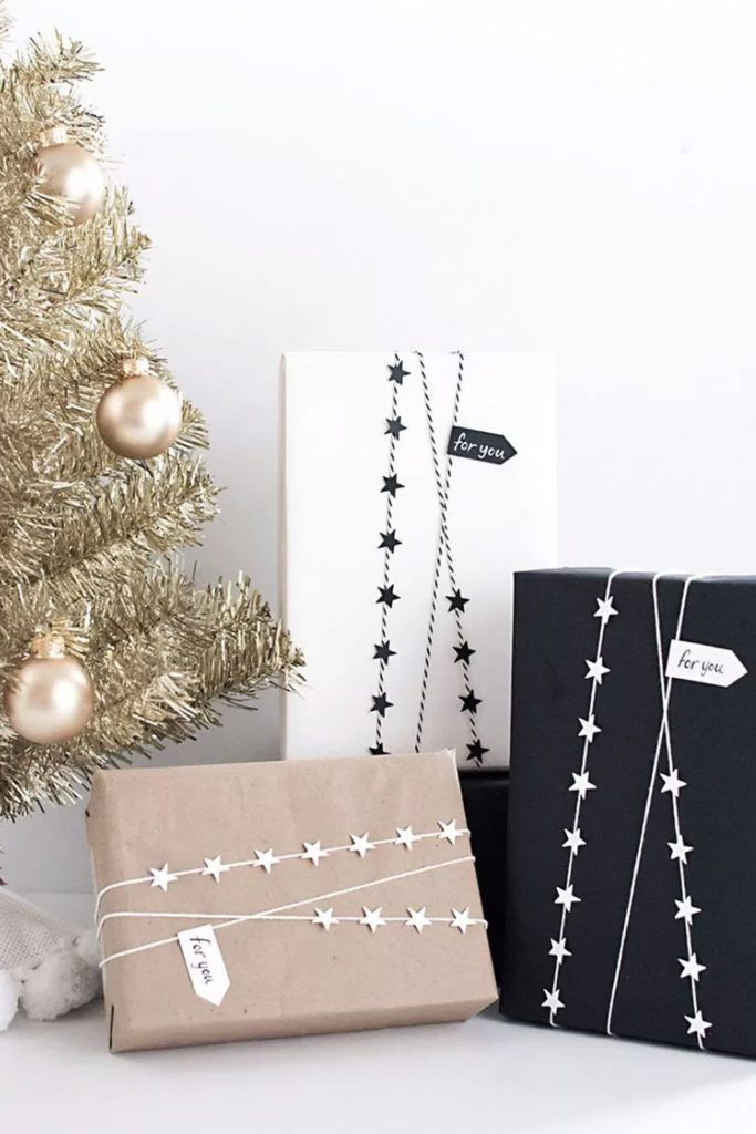 This gift wrap is simple with black, white, and brown wrapping, accented with sparkling black and white star rope