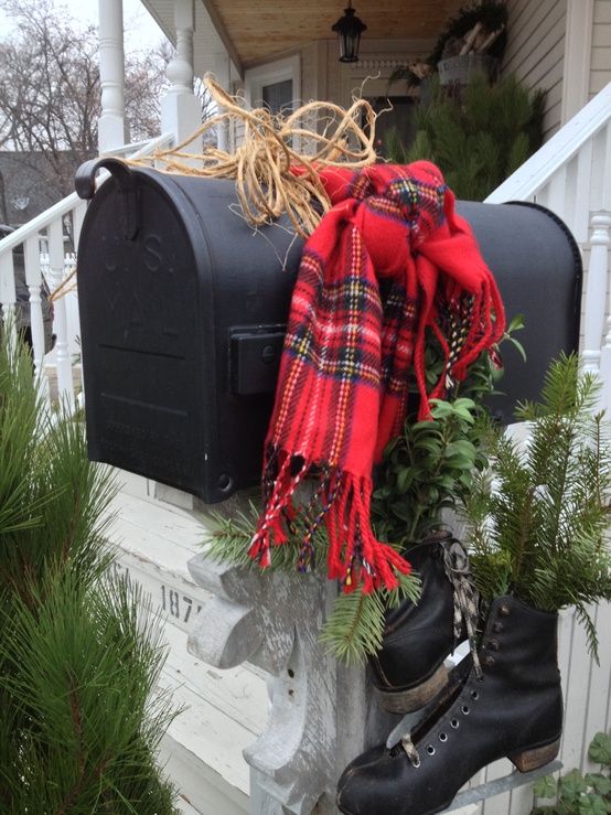 This Christmas mailbox is decked out with a festive red plaid scarf and some ice stakes!