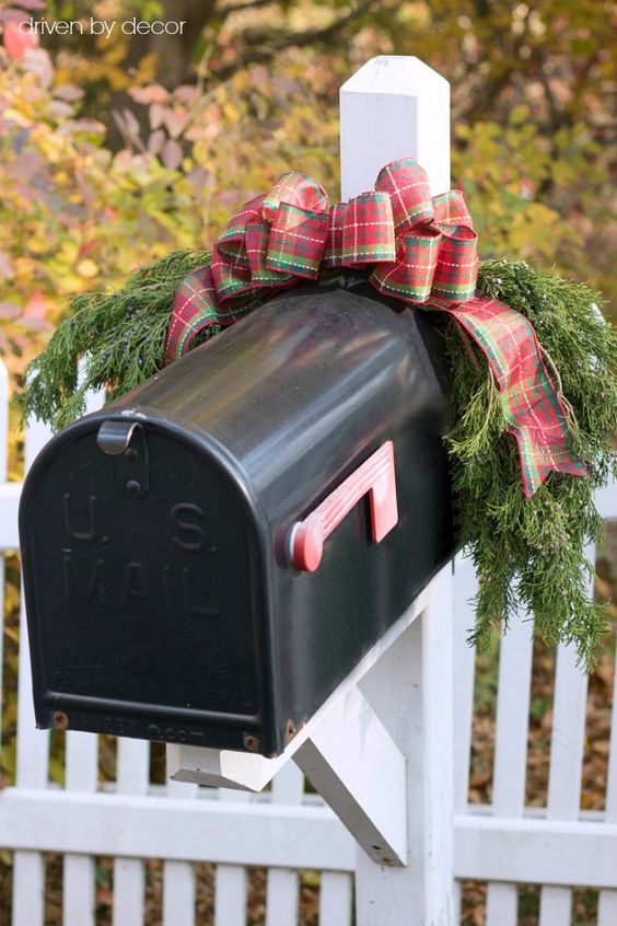 This Christmas mailbox is simply decorated with some plaid ribbon and fresh balsam tree branches