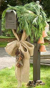 This simple Christmas mailbox is subtle with a burlap bow and some fresh green balsam branches