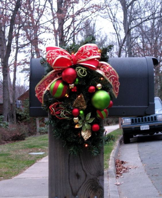 This Christmas mailbox is simple and festive with a red bow and wreath donned with Christmas ornamments