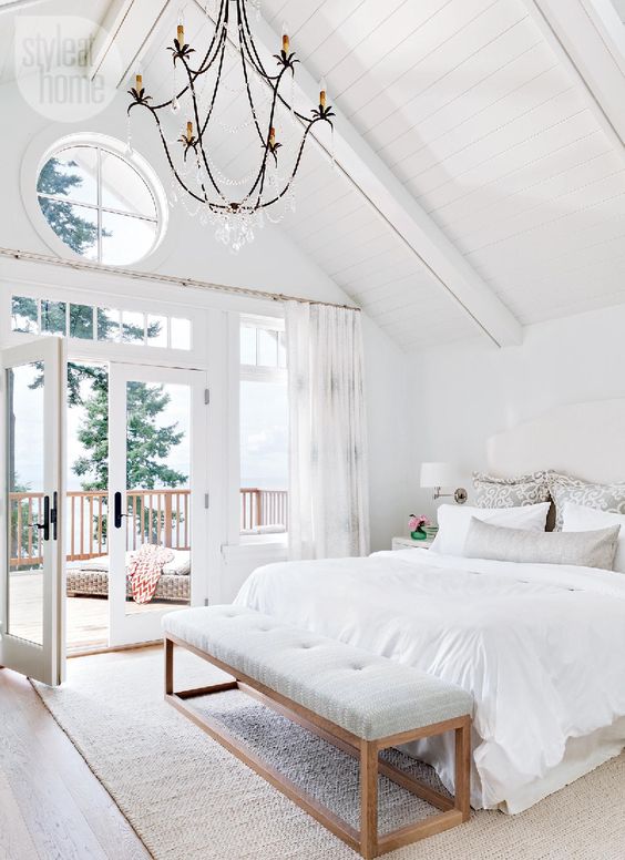 This grand master bedroom is a cozy getaway, with high shiplap ceilings and private deck 