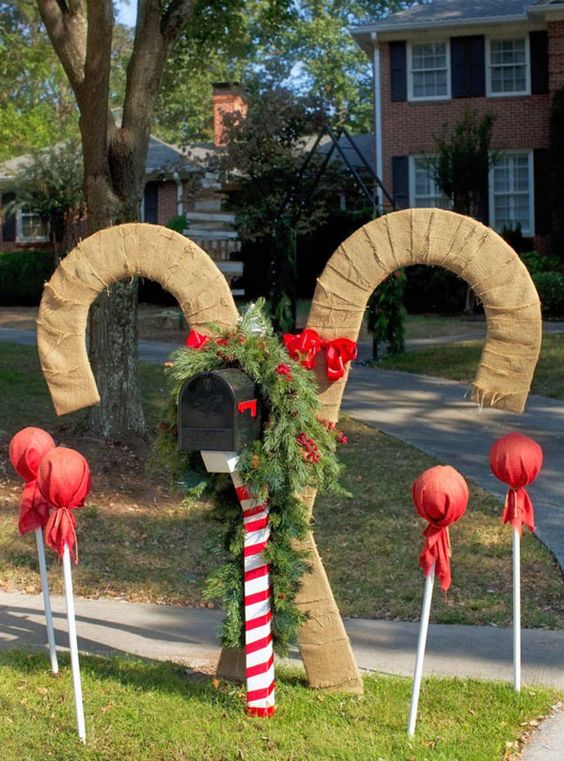 This Christmas Mailbox scene includes large burlap candy canes, lollipops, and a festive Christmas wreath