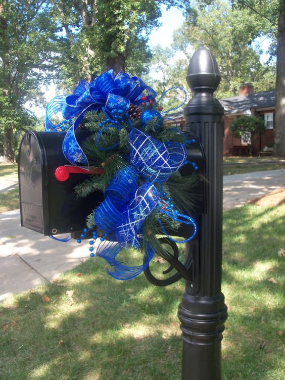 This Christmas mailbox is simple and elegant with blue sparkling ribbon and fresh pine branches