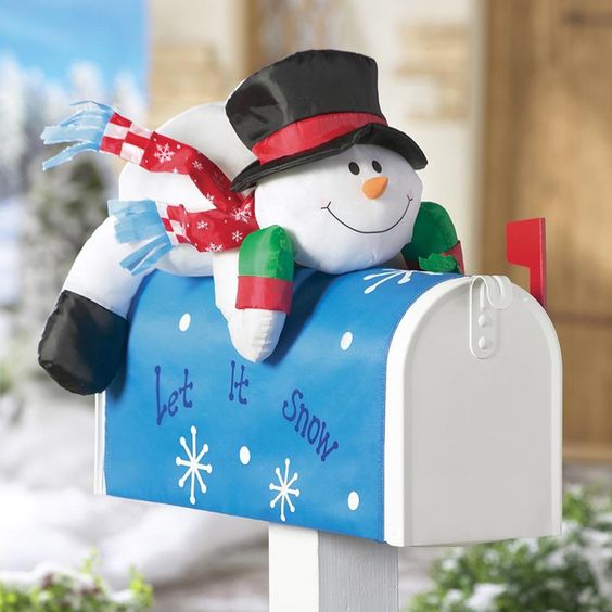 This Christmas mailbox has a cute stuffed snowman and a let it snow banner to make it festive and fun