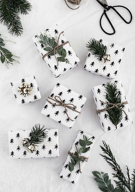 Adding simple touches like fir branches and silver bells to your gift wrapping gives it that extra special touch