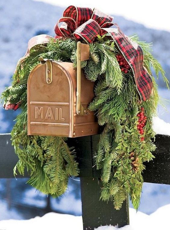 This Christmas mailbox is decked out with plaid ribbon and gorgeous full pine tree firs 