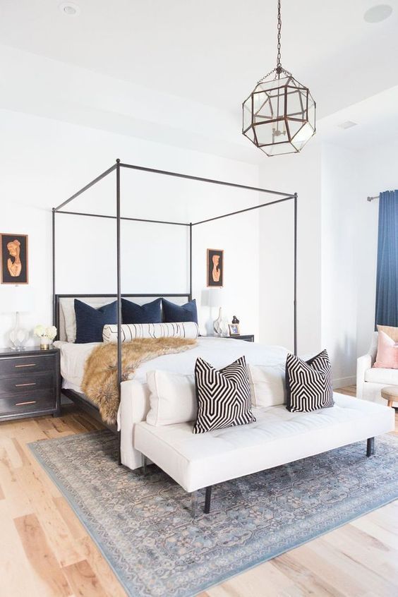 The focus of this all-white room is the colorful and bold throw pillows! I love how this bedroom is a clean canvas that you can reinvent.