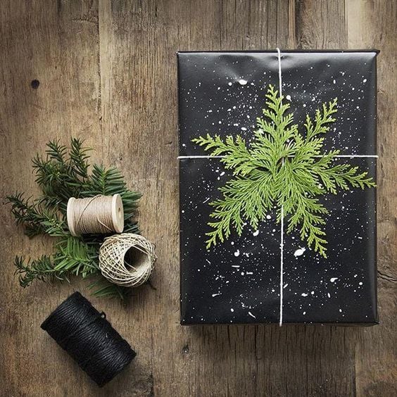 Some white twine and pine tree branches give this simple black gift wrap the perfect holiday touch