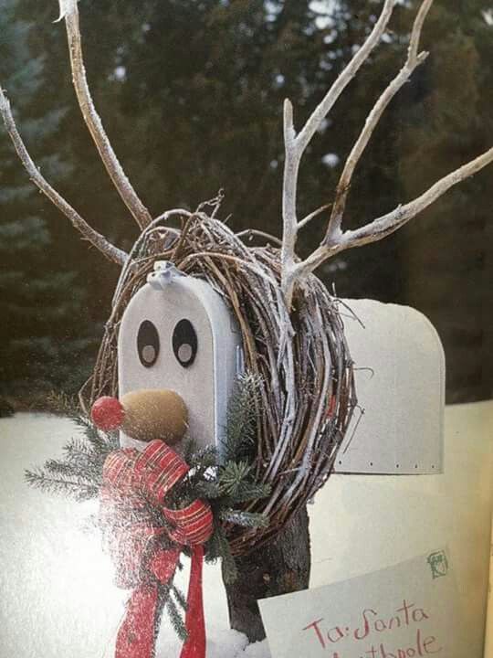 This Christmas mailbox is decorated like a snowy reindeer complete with wooden antlers