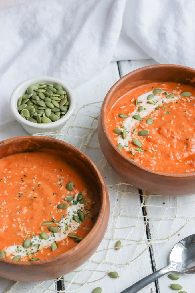 Two bowls of Spiced Pumpkin Soup; Warm roasted pumpkin pureed soup with a kick of spicy undertones. Fall/autumn comfort food! {Healthy Vegan, Gluten Free, Refined Sugar Free, Dairy Free} 