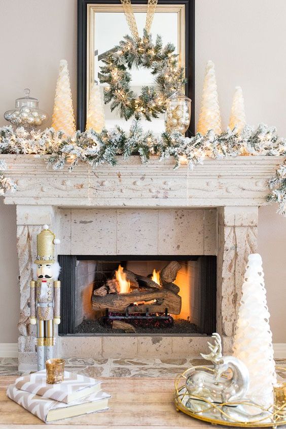 This white and gold Christmas mantle has pops of green and plenty of sparkle