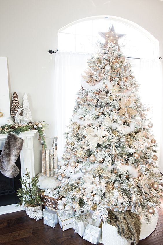 This white and gold Christmas tree has stars, garland, and even fake snow! 