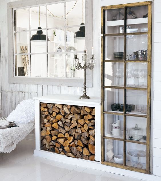 Stylish Ways To Store Wood in Your Home; cute and high style ways to hide or display wood in your home when you have a fire place or a wood burning stove. Bring on the heat and adorable piles of wood! #woodstove #fireplace #storingwood #woodpiles