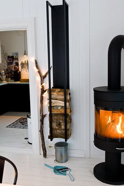 Stylish Ways To Store Wood in Your Home; cute and high style ways to hide or display wood in your home when you have a fire place or a wood burning stove. Bring on the heat and adorable piles of wood! #woodstove #fireplace #storingwood #woodpiles