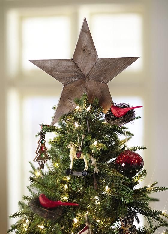 The tree topper is the shining star of Christmas tree decor! I love this rustic wood tree star