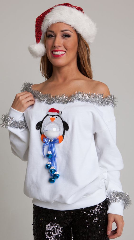 Rock this stylish off-the-shoulder Christmas sweater with an adorable little penguin and festive bells