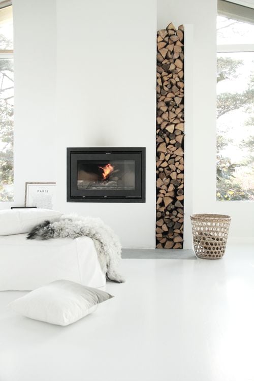 Stylish Ways To Store Wood in Your Home; cute and high style ways to hide or display wood in your home when you have a fire place or a wood burning stove. Bring on the heat and adorable piles of wood! #woodstove #fireplace #storingwood #woodpiles